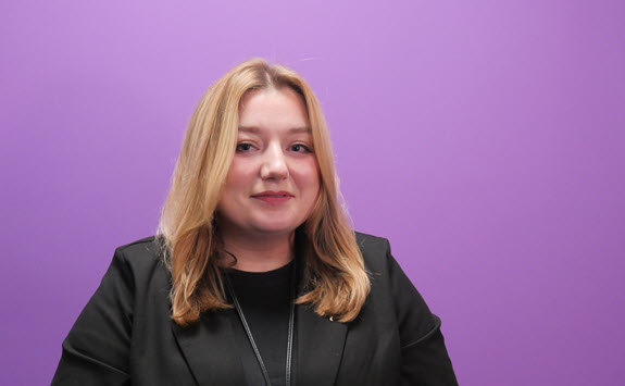 Photograph of Gemma Wain with a purple background.